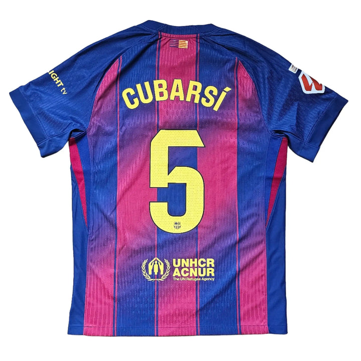 Back view displaying No. 5 and name Cubarsí on a blue and red football shirt with UNHCR logo.