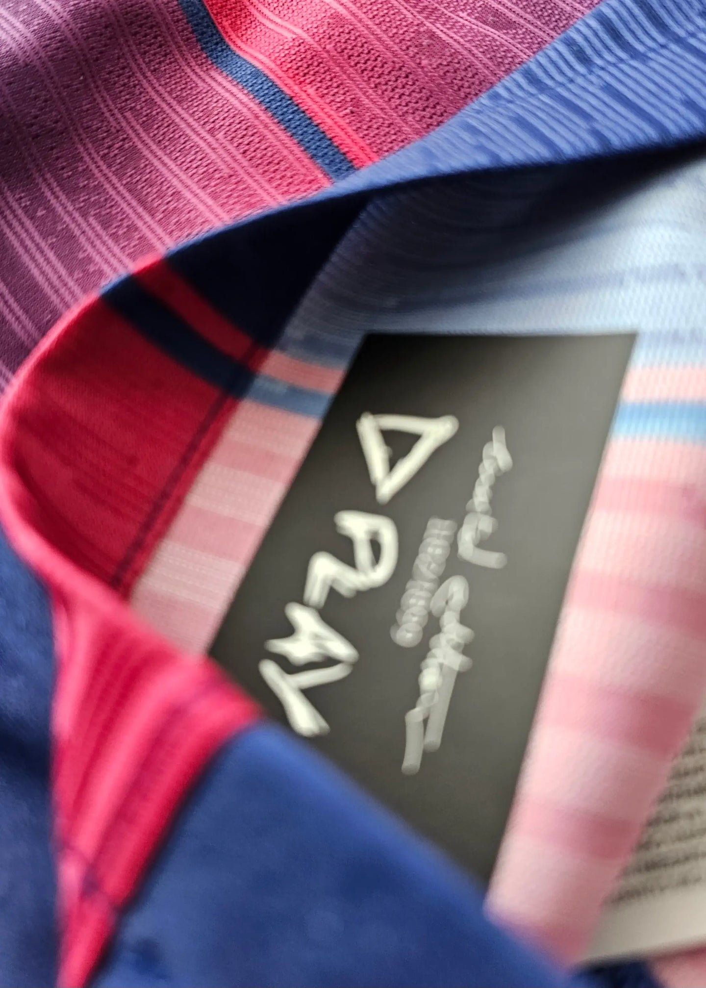 Interior view showing the tag with PLAY and colorful patterned fabric in blue and red.
