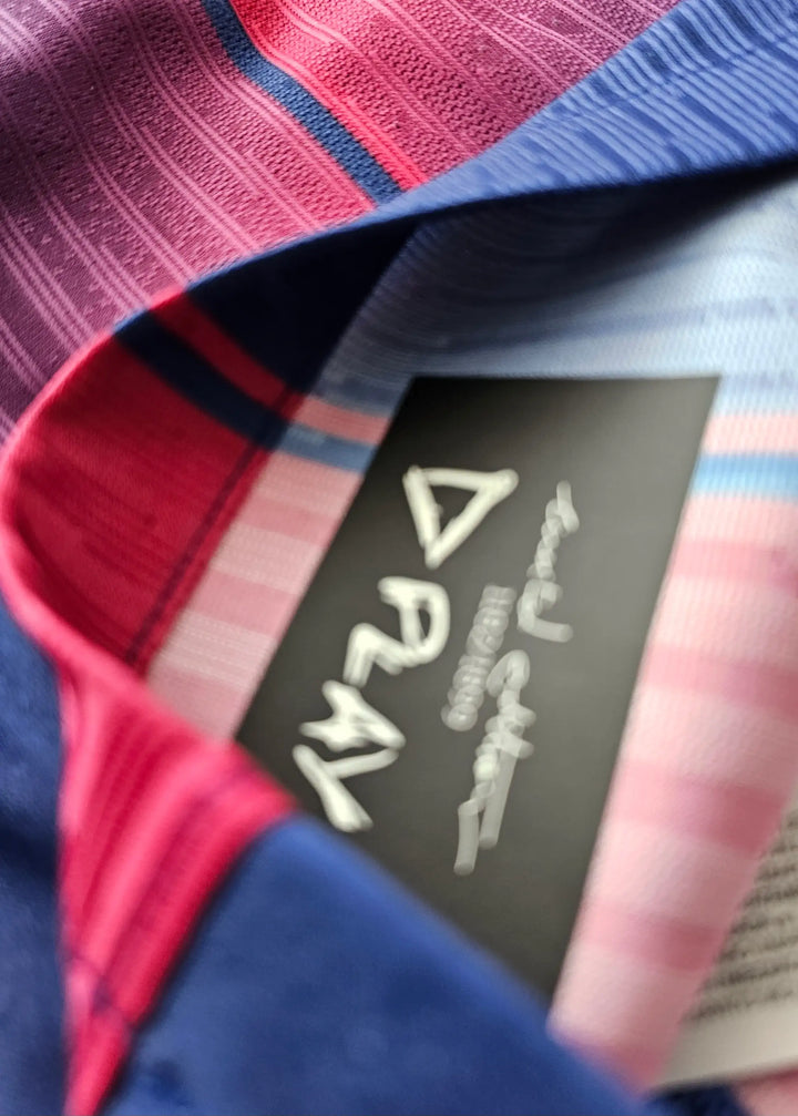 Interior view showing the tag with PLAY and colorful patterned fabric in blue and red.