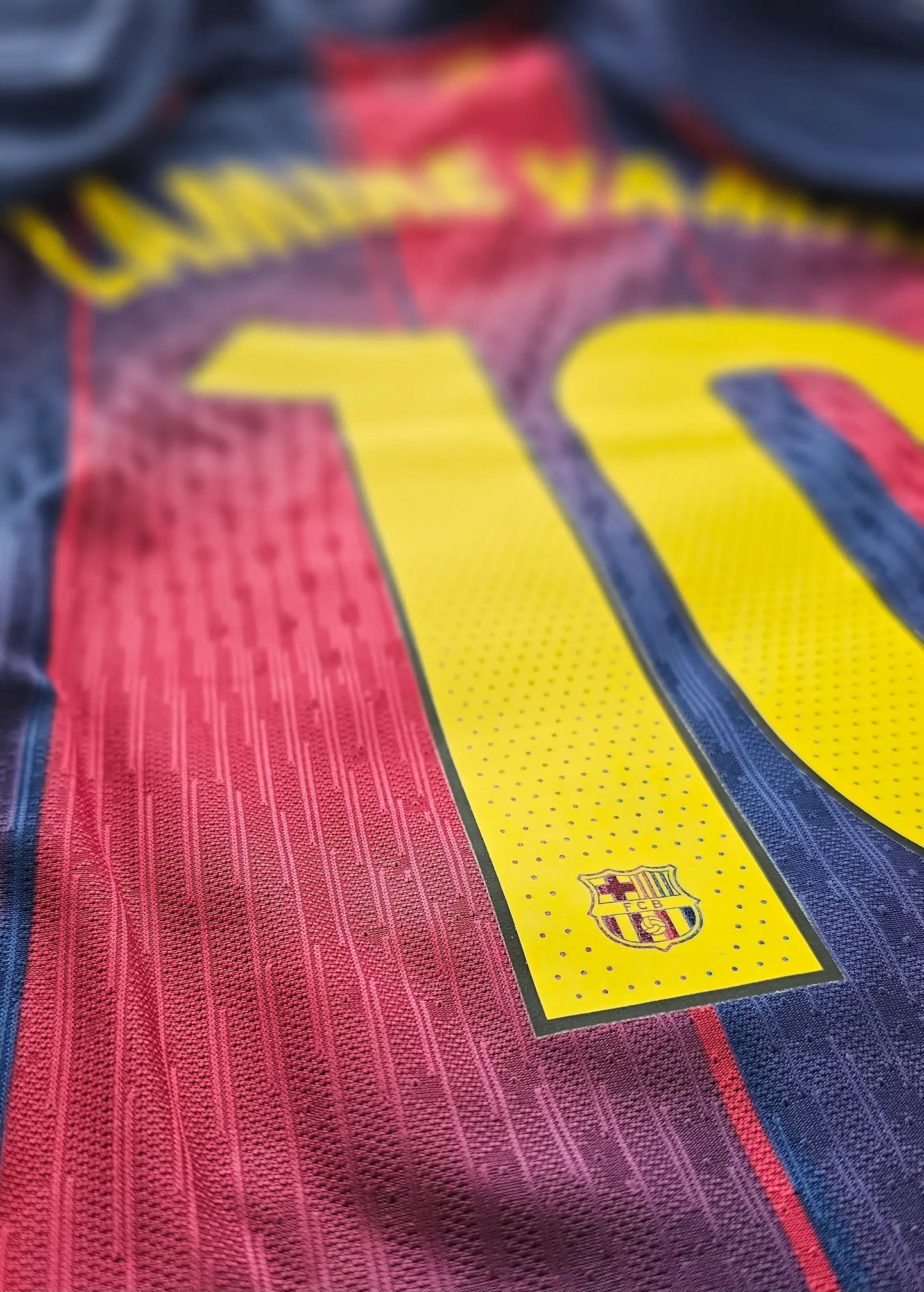 Close-up of Barcelona No. 10 with Lamine Yamal's name and the club crest.