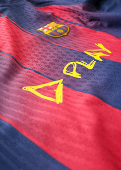 Close-up detail showing the FC Barcelona crest and playful yellow 'ED SHEERAN PLAY' text.