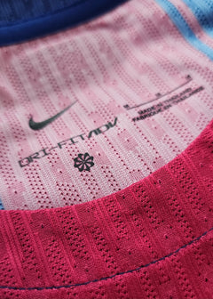 Detail view showing the Nike logo, DRIFT FIT ADV text, and size M label in pink and blue.