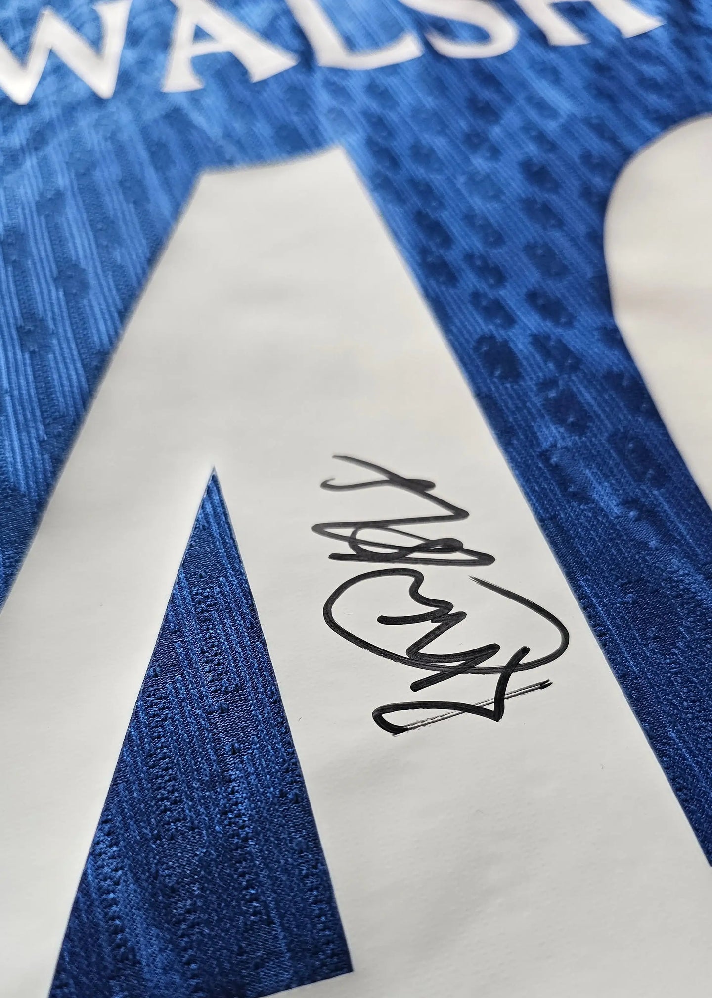 Close-up of the signature of Walsh on a blue Chelsea football shirt with No. 46.