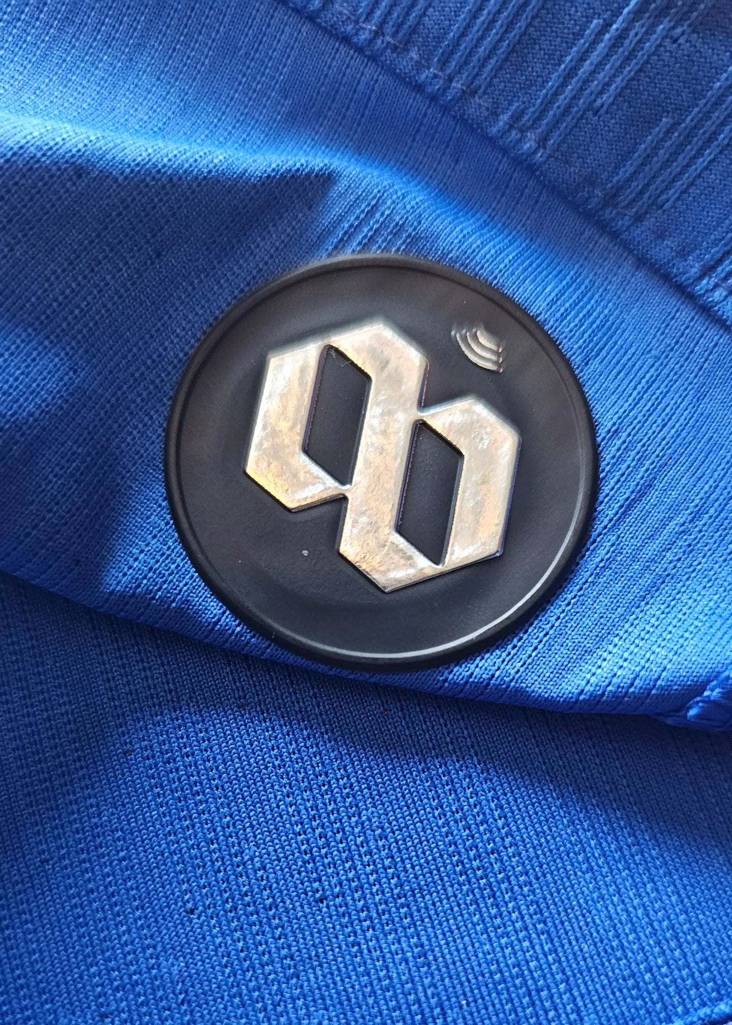 Close-up of Chelsea crest on a blue football shirt with a textured finish.