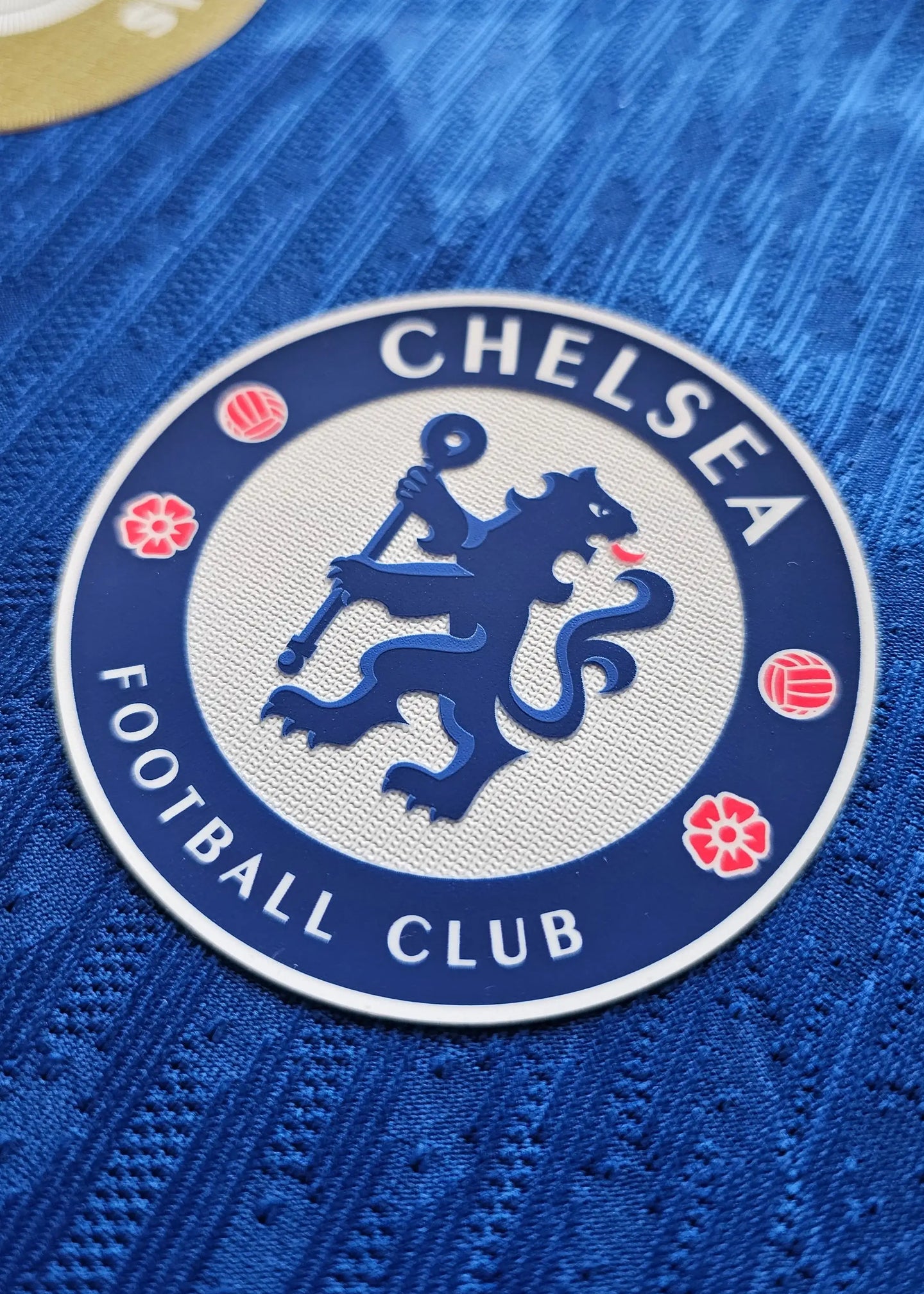 Detailed view of the Chelsea F.C. crest featuring a lion, with the text 'CHELSEA' and 'FOOTBALL CLUB'.