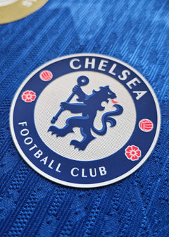 Detailed view of the Chelsea F.C. crest featuring a lion, with the text 'CHELSEA' and 'FOOTBALL CLUB'.