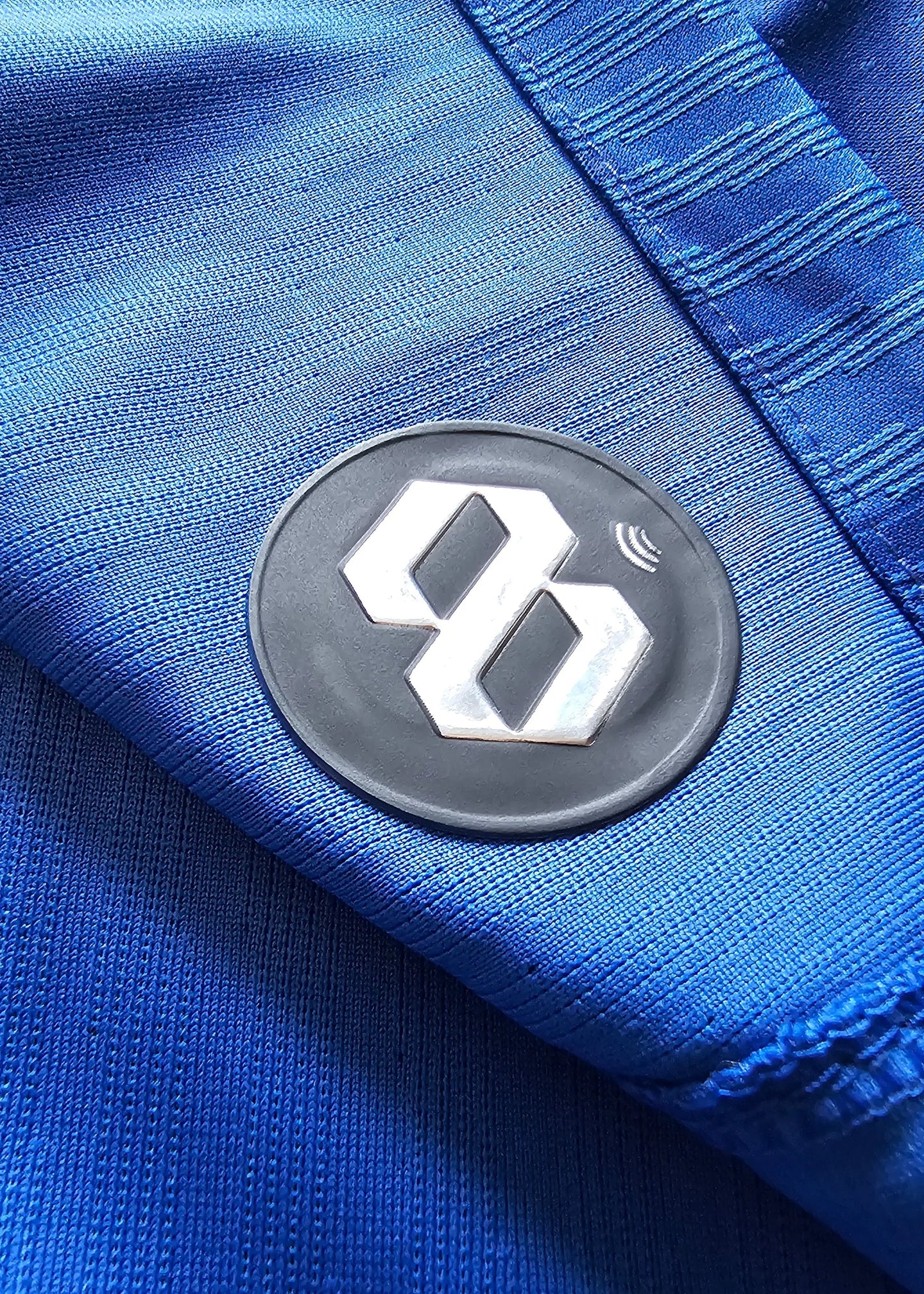 Detail view showing the black and silver 88 logo on the blue football shirt.