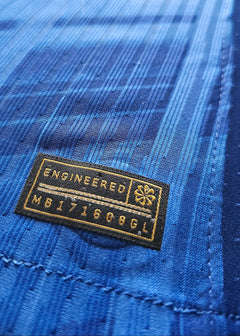 Close-up detail showing the fabric texture and the 'ENGINEERED MB171608GL' tag in blue.