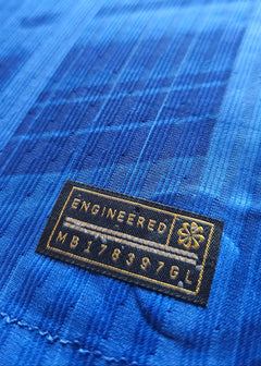 Close-up view showing the engineered label with text 'ENGINEERED MB178397GL' on blue fabric.