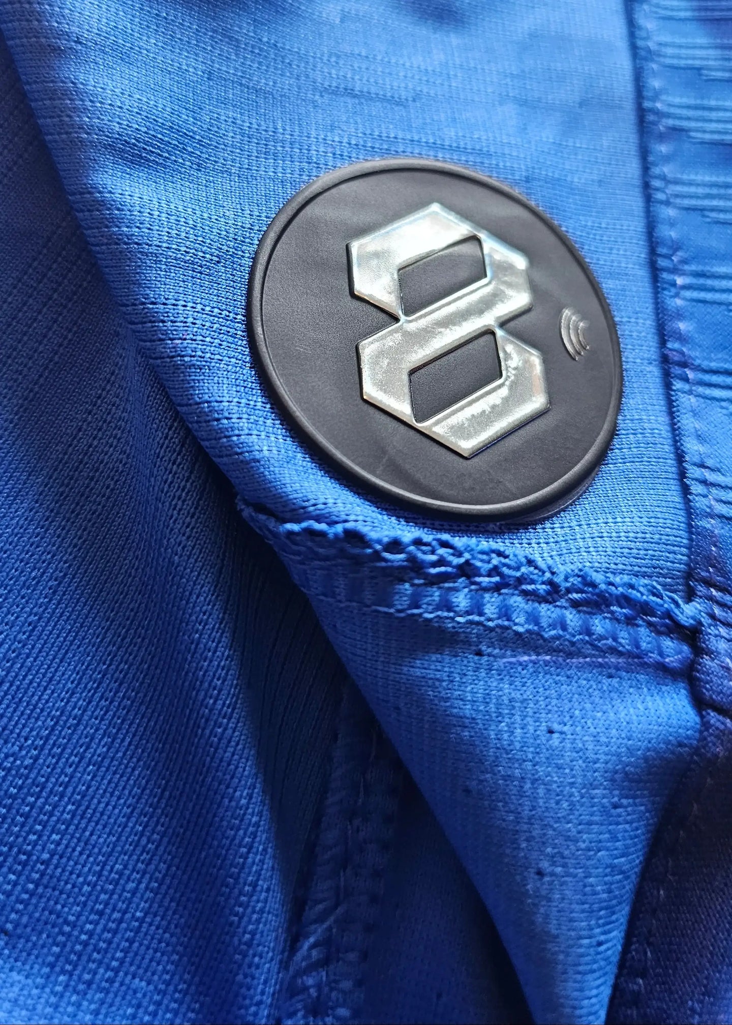 Close-up of the blue fabric showing the 8 logo detail on the sleeve of the Chelsea shirt.