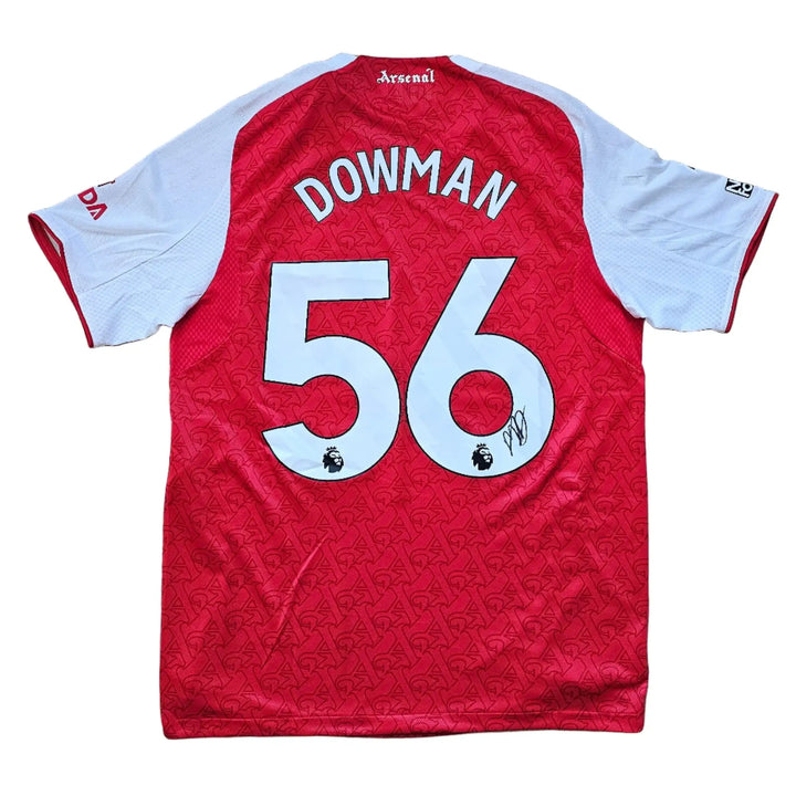 Back view showing Dowman name, No. 56, and signature on a red and white Arsenal football shirt.