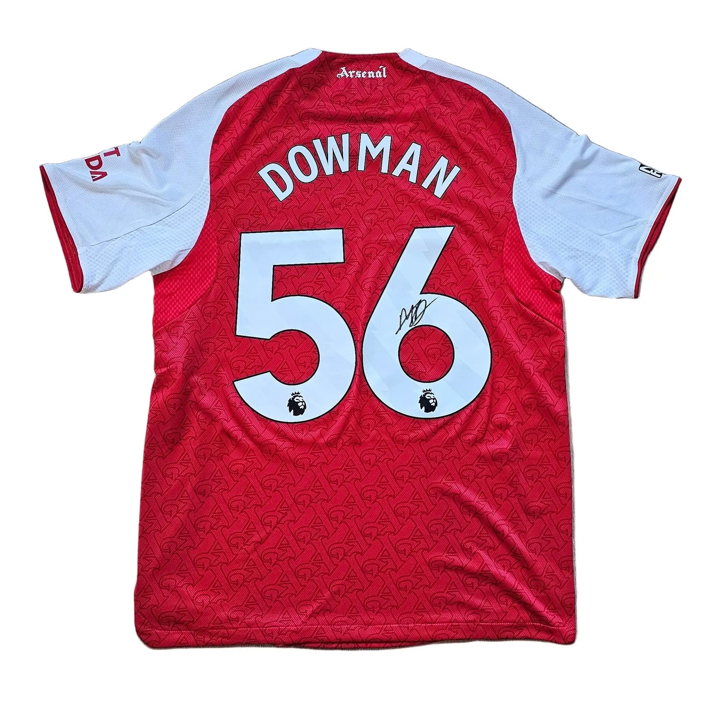 Back view showing No. 56 and the signature of Dowman on a red and white football shirt.