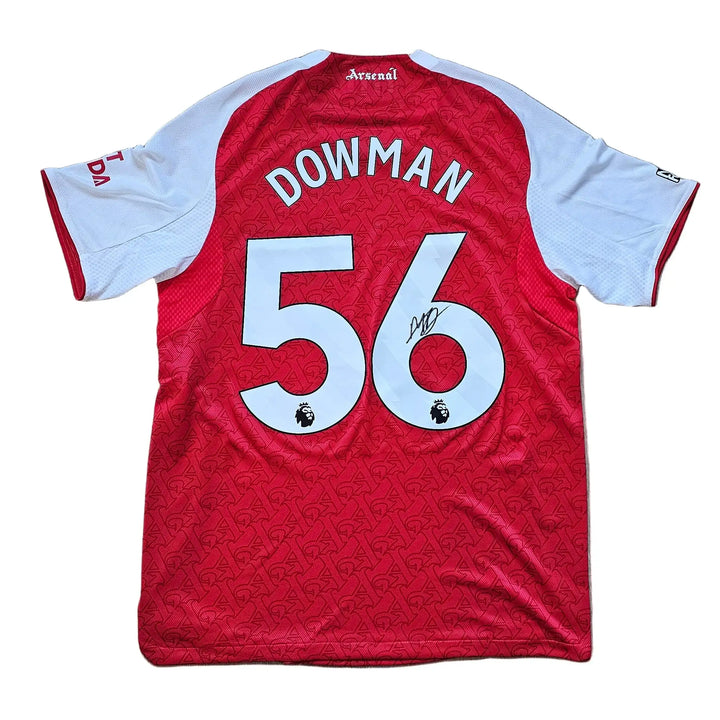 Back view showing No. 56 and the signature of Dowman on a red and white football shirt.
