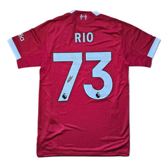 Back view showcasing name 'RIO', No. 73, and signature on a red football shirt.