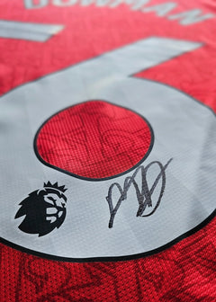 Signature detail with the name Dowman and No. 56 on a red Arsenal football shirt.