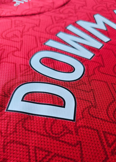 Close-up view showing the name 'DOWMAN' on a red Arsenal F.C. football shirt.