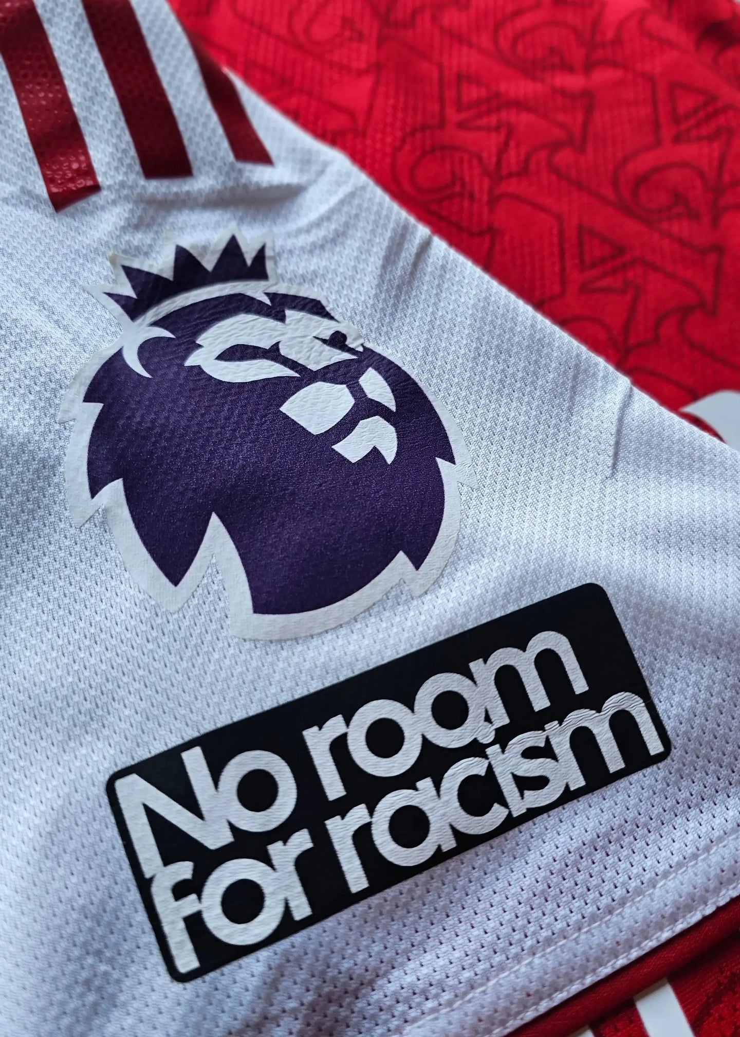 Detail view showing the Premier League lion crest and 'No room for racism' message.