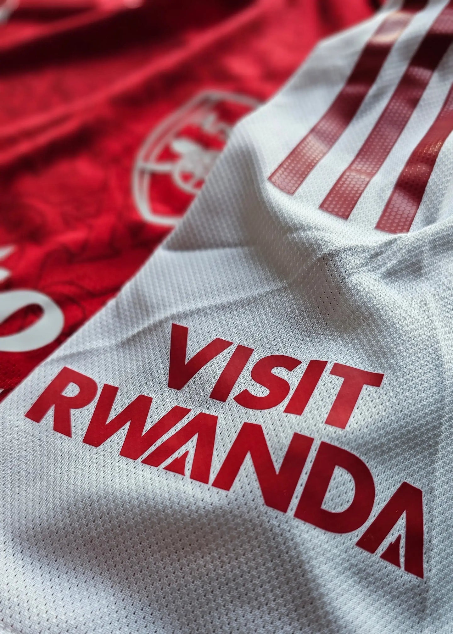 Detail showing white section with red stripes and 'VISIT RWANDA' text.