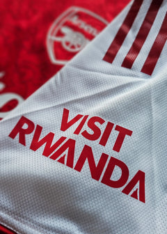 Back view showing the white panel with 'VISIT RWANDA' in red and part of the Arsenal crest.