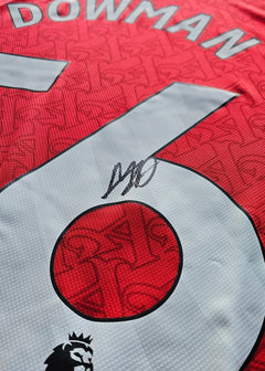 Close-up of signature and No. 56 on the red Arsenal football shirt with Dowman name visible.