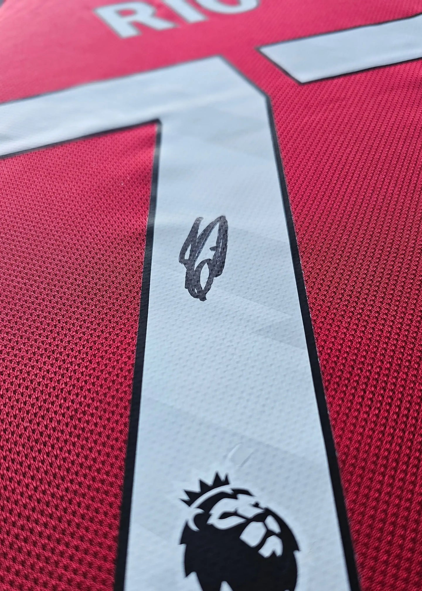 Close-up of the signature on Rio Ngumoha's No. 73 Liverpool F.C. football shirt.