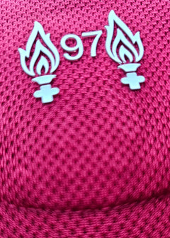 Detail view showing the No. 97 with two flames emblem on a red football shirt.