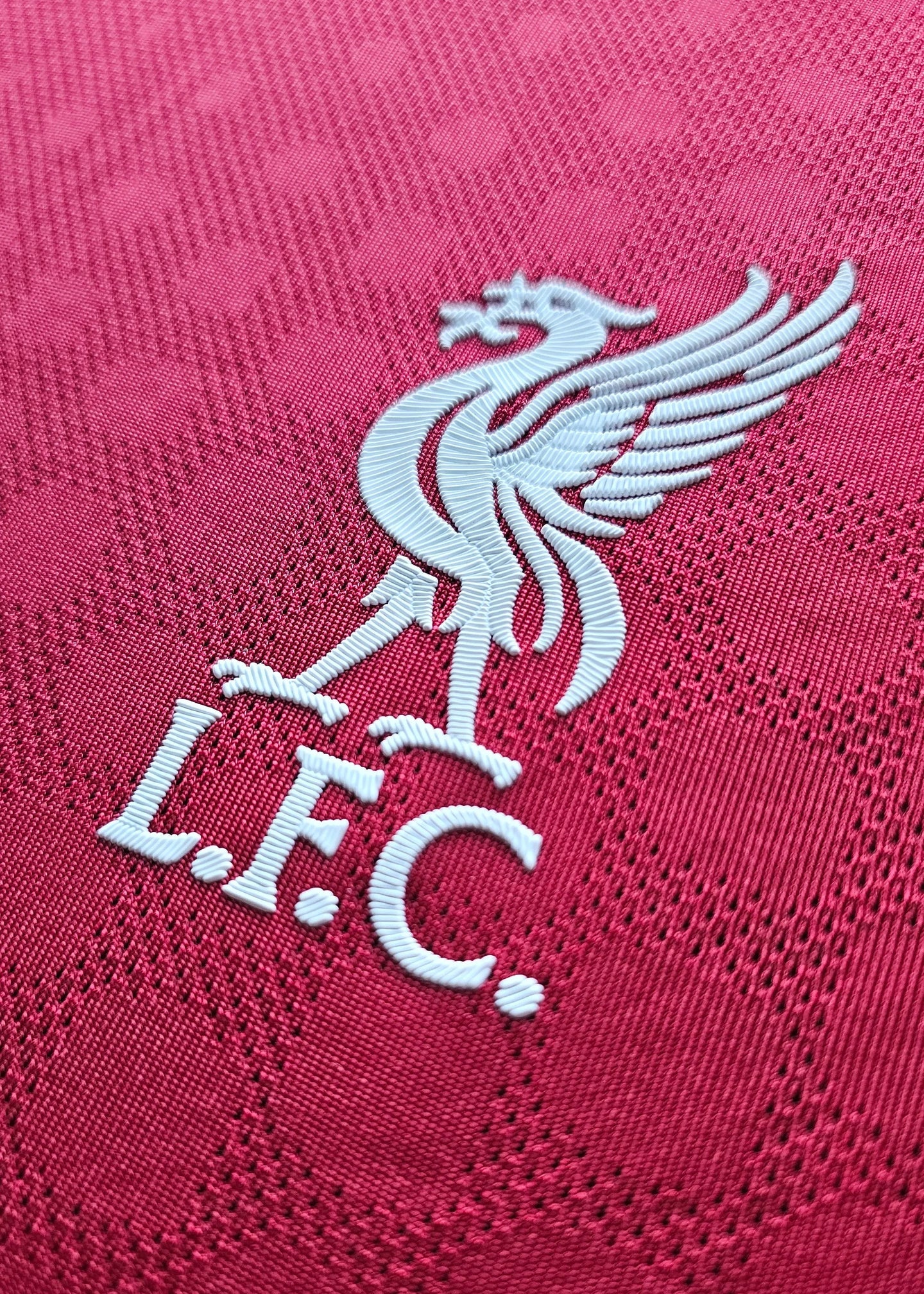 Crest detail of Liverpool F.C. featuring a white embroidered liver bird and 'L.F.C.' text.