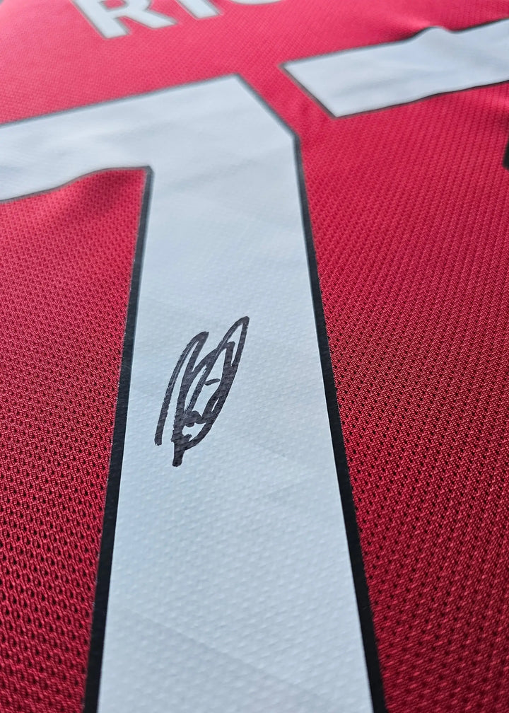 Close-up of signature and No. 73 on a red Liverpool football shirt.