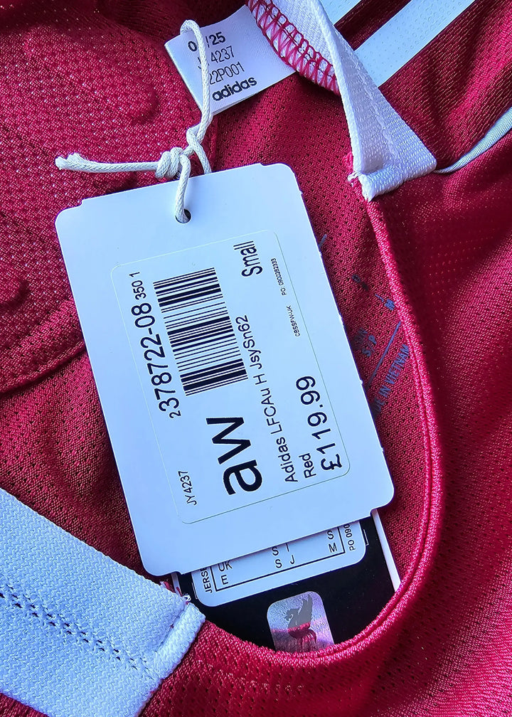 Size tag showing 'Small', brand 'adidas', and price '£119.99' on a red football shirt.