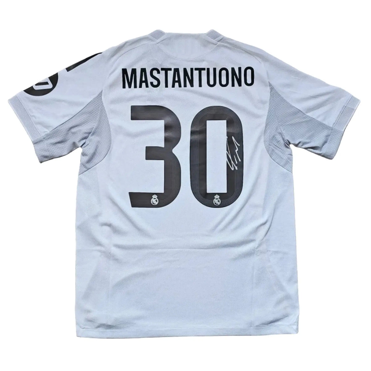 Back view showing No. 30, Mastantuono, and a visible signature on a white football shirt.