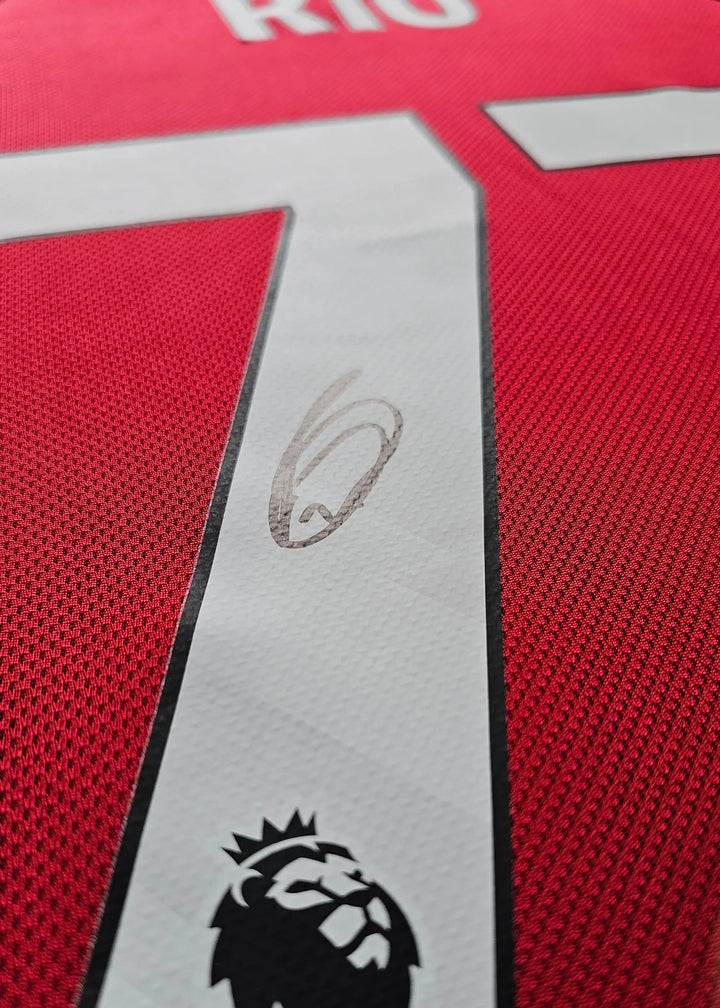 Close-up of No. 73 and signature on red football shirt featuring Premier League lion crest.