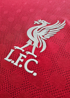 Close-up of the Liverpool F.C. crest featuring the Liver bird and 'L.F.C.' text in white.
