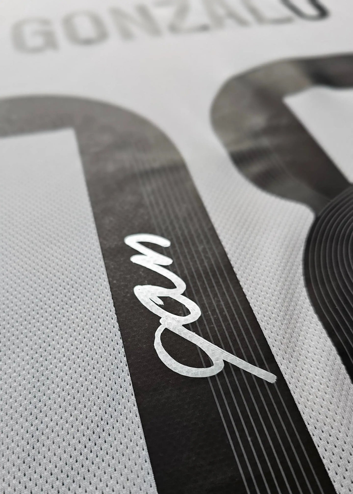 Detail view showing the name 'Gonzalo' and the No. 30 with a signature underneath.