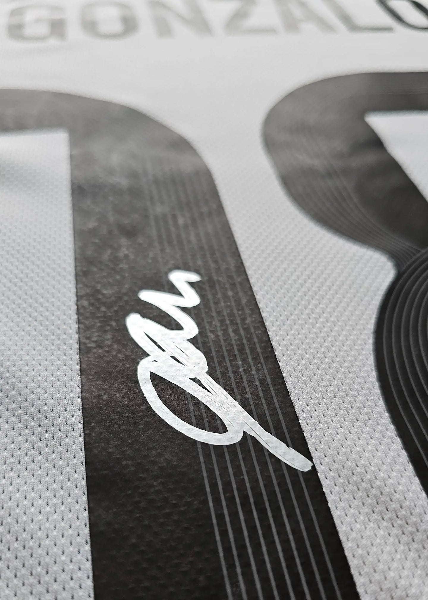 Close-up of Gonzalo Garcia's signature on the No. 24 Real Madrid football shirt.