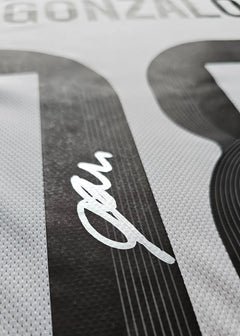 Close-up of Gonzalo Garcia's signature on the No. 24 Real Madrid football shirt.