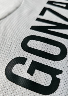 Close-up detail displaying the name 'GONZALO' in bold black letters on a white shirt.