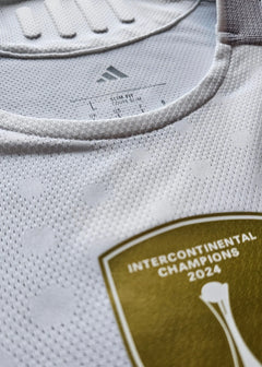 Close-up view showing adidas logo, size L label, and Intercontinental Champions 2024 badge.