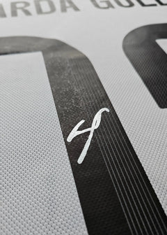 Close-up showing the signature of Arda Güler and the number 30 on a football shirt.