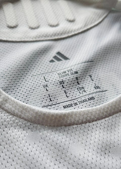 Care label showing size L, slim fit details, and made in Thailand.