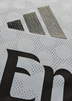 Close-up of the white fabric featuring the adidas logo and the Real Madrid lettering.