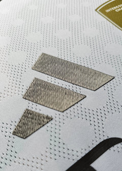 Close-up of the metallic sponsorship details on the white signed football shirt.