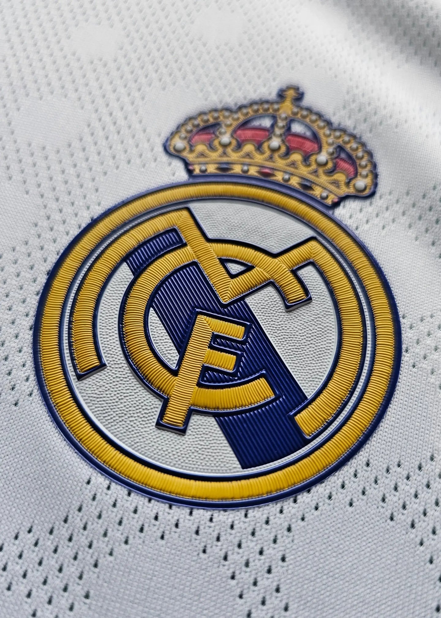 Close-up of the Real Madrid CF crest featuring a crown and intricate embroidery details.