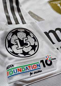Detail showing UEFA Foundation 10 Years logo, No. 15 with starball design.