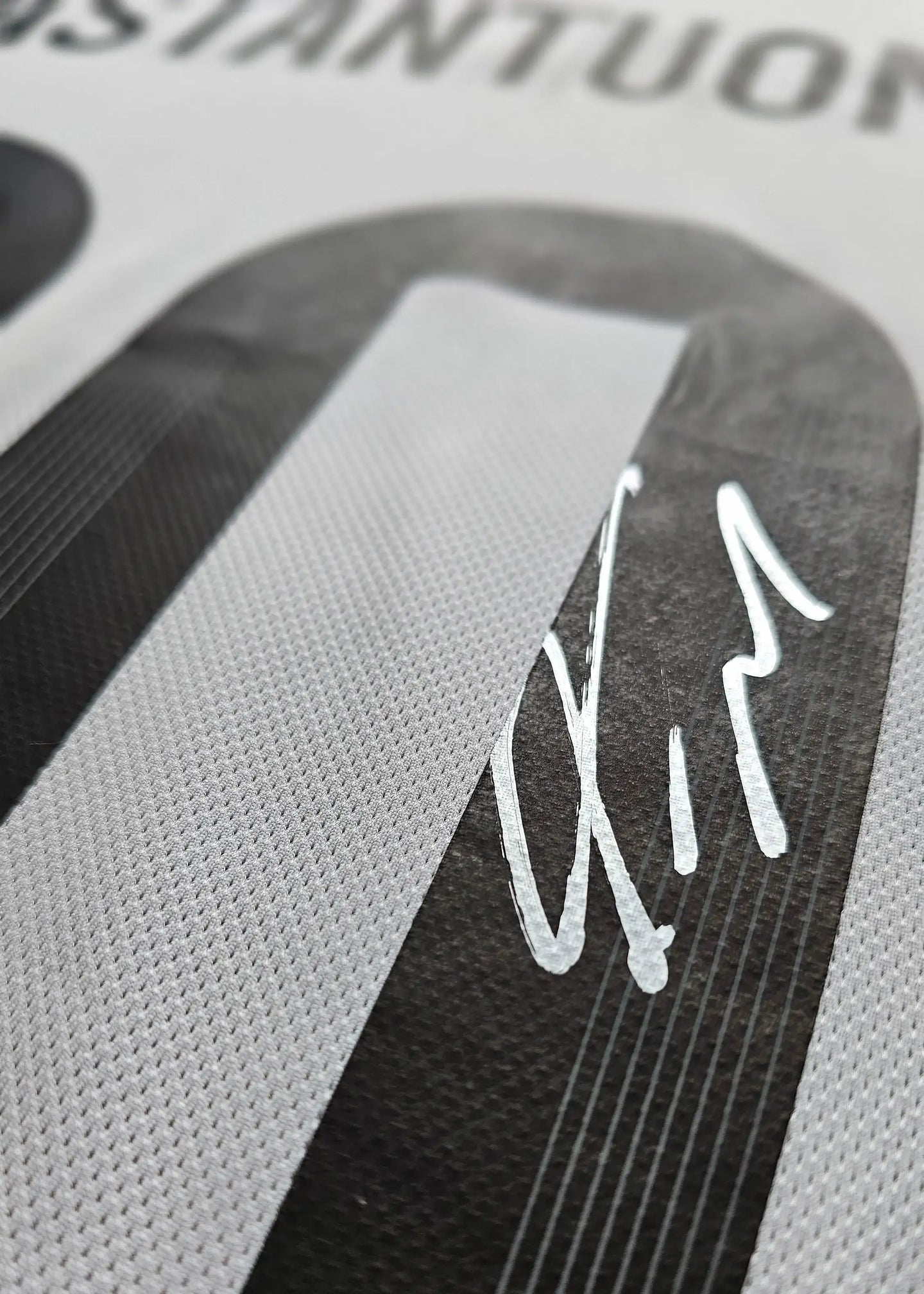 Close-up showing No. 10 and Franco Mastantuono's signature on the football shirt.