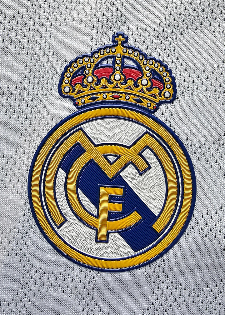 Detail of Real Madrid CF crest featuring intricate embroidery and a crown.