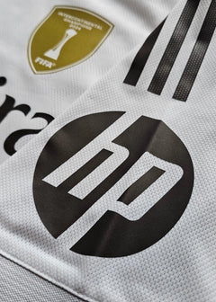 Detail view featuring Real Madrid crest and HP sponsor logo on a white background.