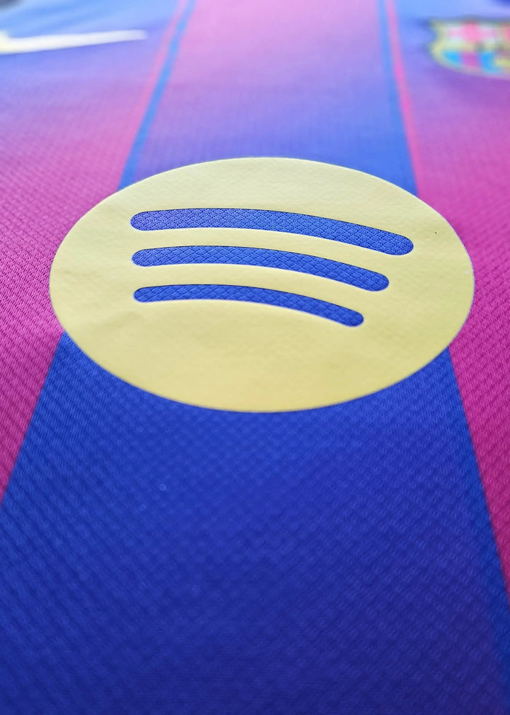 Detail view showing the yellow Spotify logo on the blue and purple FC Barcelona football shirt.