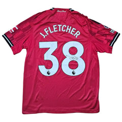 Back view displaying J. Fletcher, No. 38, with a visible signature on a red football shirt.