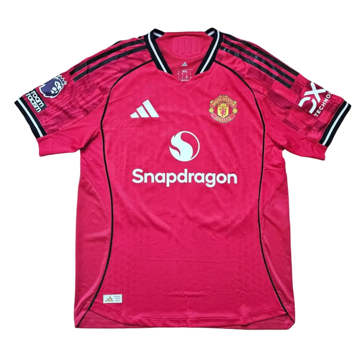 Front view showing Manchester United crest, No. 39, and Snapdragon sponsor on a pink football shirt.