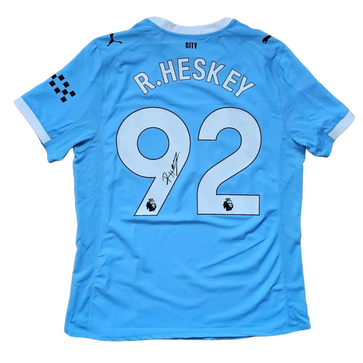 Back view showing R. Heskey, No. 92, and a signature on a blue football shirt.